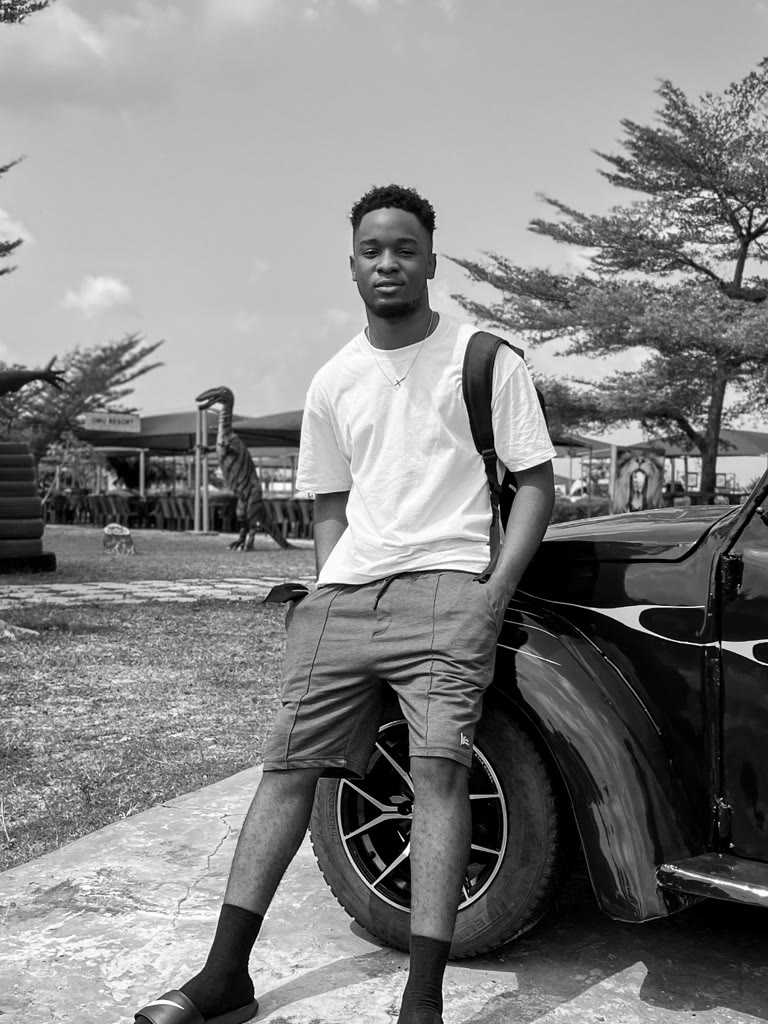 Emmanuel Ochem, standing beside a car